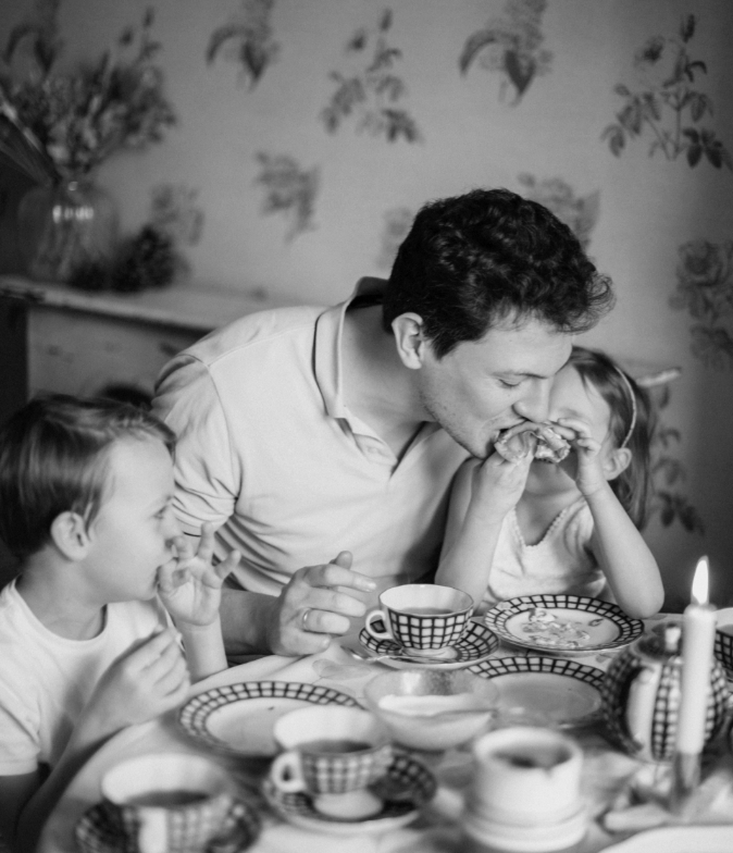 Father and childern drinking tea